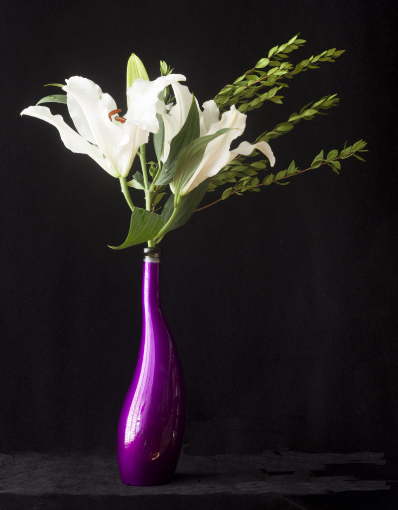 White Asiatic Lilies in a Purple Vase